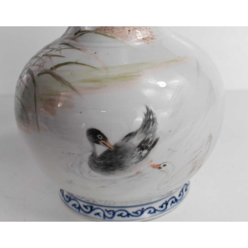 35 - A 20th century Chinese bottle vase, in underglaze blue and white, and overglazed hand painted ducks ... 