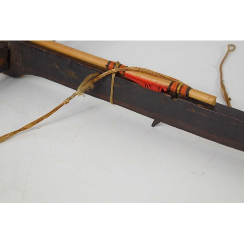 356 - An antique wooden crossbow, the bow having a wooden trigger, possibly tribal, 65cm by 76cm.