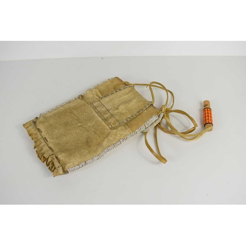 380 - A Native American hide and beadwork bag / pouch, highly decorated with coloured beads, 26cm by 16cm.