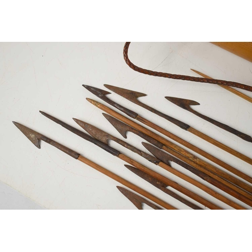 391 - A bamboo arrow quiver and cover, Borneo region, 77cm, together with a group of arrows with single ba... 