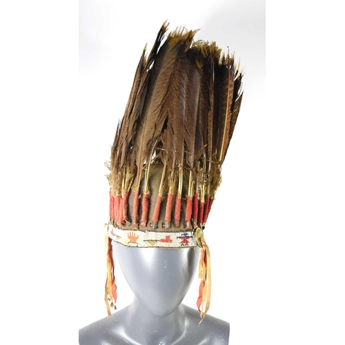 419 - A Native American Plains, war bonnet headdress, the bonnet decorated with thirty-one eagle feathers ... 