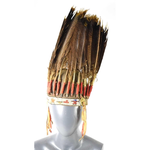 419 - A Native American Plains, war bonnet headdress, the bonnet decorated with thirty-one eagle feathers ... 