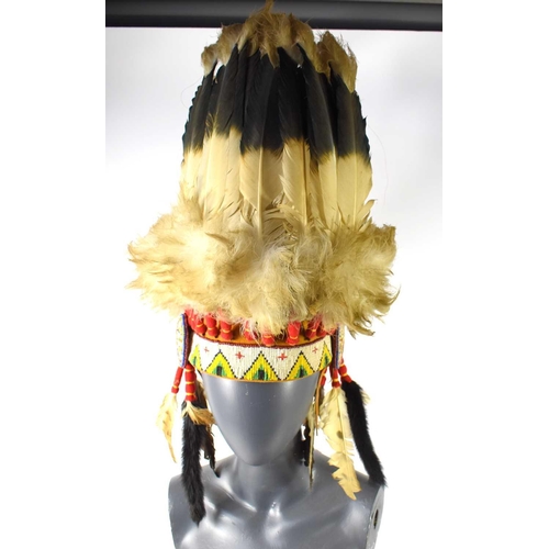 420 - A 20th century Native American war bonnet with thirty-one Golden eagle feathers, the bonnet decorate... 