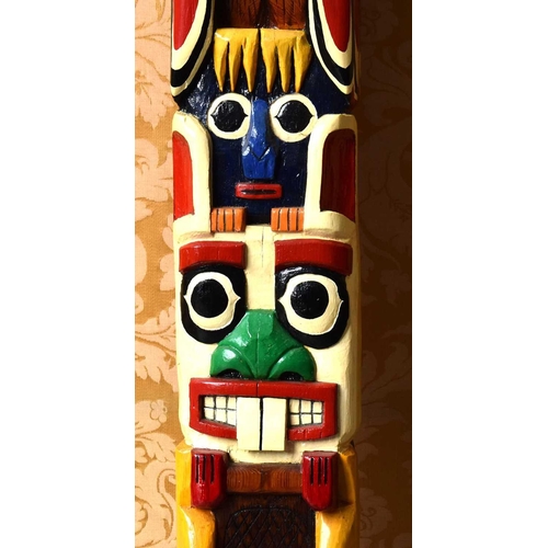 423 - A large Native American carved wooden Totem pole, carved and painted with figures, 21cm by 9cms x 20... 