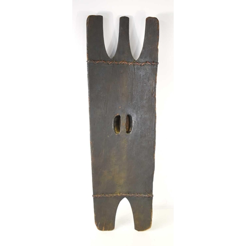 426 - A Bontoc head-hunters shield, Luzon, Philippines, with an integral handle and fibre binding, 94cm.