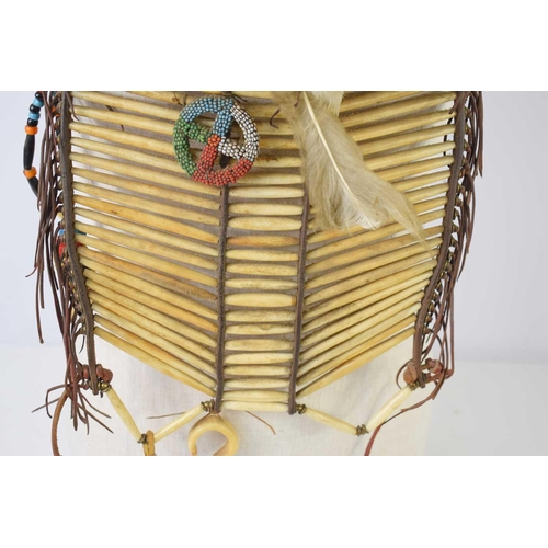 429 - An early 20th century Native American warriors breastplate, composed of three panels of shaped bone ... 