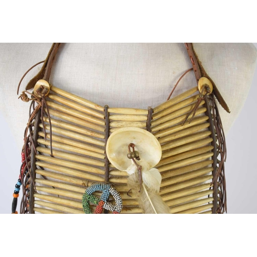 429 - An early 20th century Native American warriors breastplate, composed of three panels of shaped bone ... 