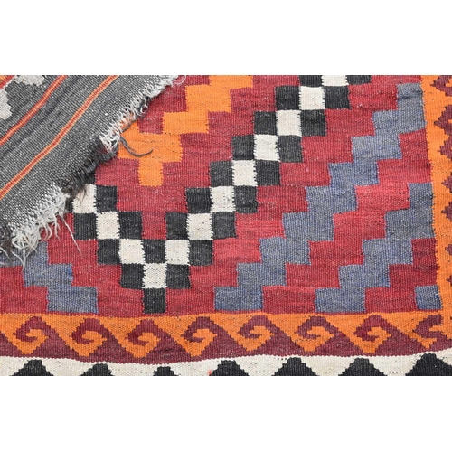 437 - Two early 20th century Middle eastern kilim rugs, with red, orange, black and white geometric patter... 