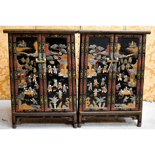 448 - A pair of Chinese two door cabinets, with hocks and a shelf, the concave shape decorated with figure... 