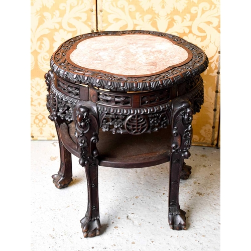 449 - A Chinese hardwood carved jardiniere stand, inset with marble top, raised on five legs, carved and p... 