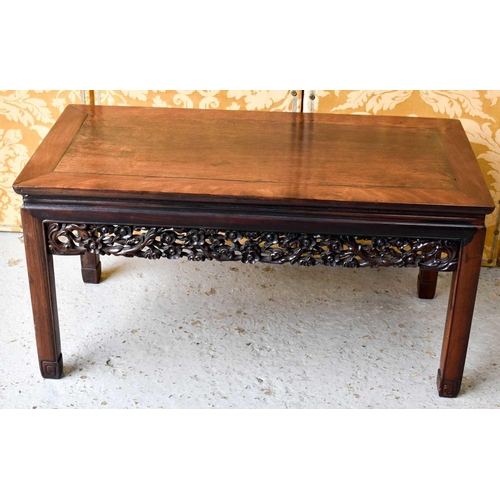 450 - A Chinese hardwood carved low table, with pierced and carved decorative rails, united with chamfered... 