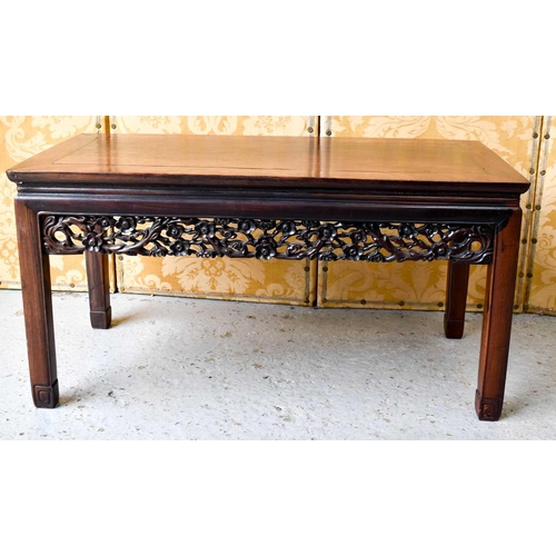 450 - A Chinese hardwood carved low table, with pierced and carved decorative rails, united with chamfered... 