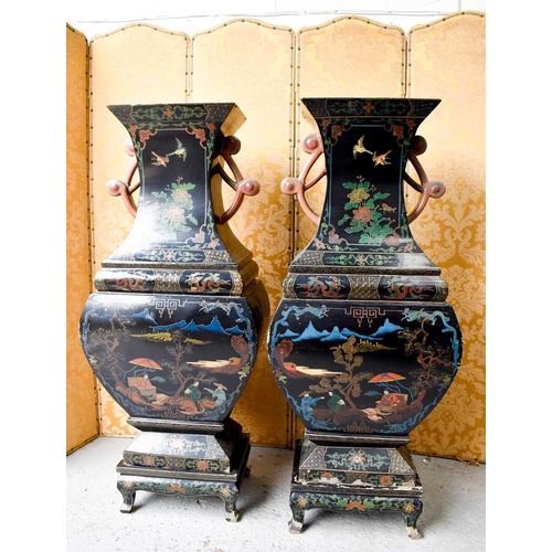 454 - A large and impressive pair of 19th century papier mache black lacquered vases, raised on wooden mat... 