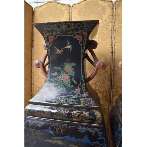 454 - A large and impressive pair of 19th century papier mache black lacquered vases, raised on wooden mat... 