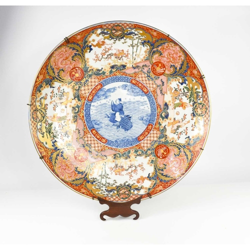 6 - A very large early 19th century Japanese Imari charger, the central blue and white roundel decorated... 