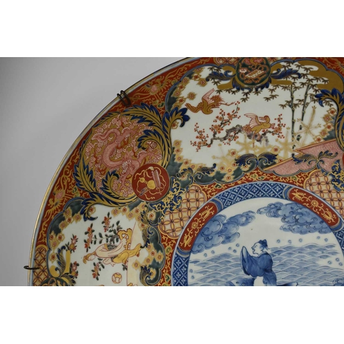 6 - A very large early 19th century Japanese Imari charger, the central blue and white roundel decorated... 