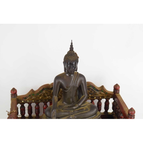 99 - A Tibetan bronze figure of Buddha Vajraasanna on a double lotus base, his right hand lowered in bhum... 