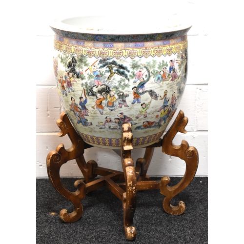 15a - A large Chinese Famille-Rose fish bowl on stand depicting figural scenes, 47cm high by 55cm.