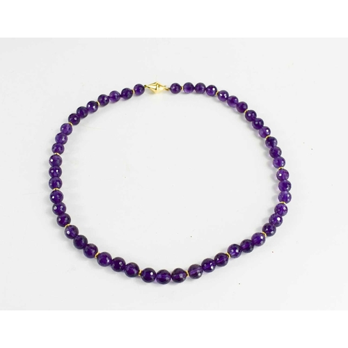 11 - An 18ct gold and amethyst necklace the fifty circular deep violet coloured beads honeycomb cut with ... 