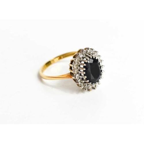 113 - A 9ct gold, sapphire and diamond ring, the oval sapphire of approximately 8.0 by 6.5mm, surrounded b... 