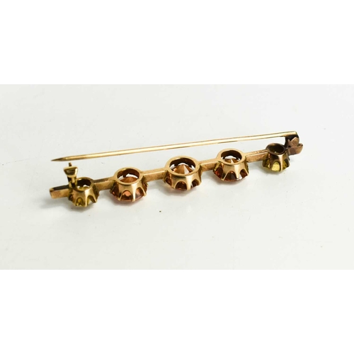 12 - A pale pink sapphire and citrine bar brooch, the central thre rose cut, peach coloured sapphires of ... 