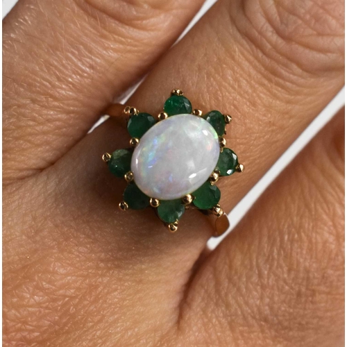 121 - A 9ct gold, opal and emerald ring, in the form of a flowerhead, size P/Q, 3.36g.