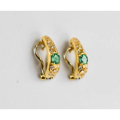 133 - A pair of 18ct gold, diamond and emerald earrings, of swelling half hoop form, each set with a centr... 