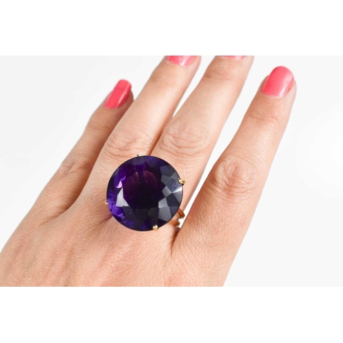 139 - A large and impressive Amethyst dress ring, the single stone of approximately 23.26mm, set in 18ct g... 