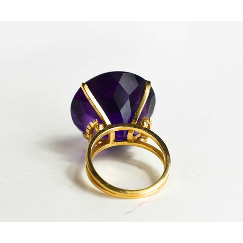 139 - A large and impressive Amethyst dress ring, the single stone of approximately 23.26mm, set in 18ct g... 