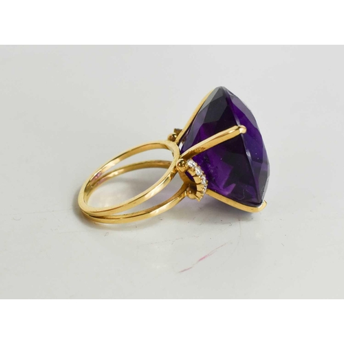 139 - A large and impressive Amethyst dress ring, the single stone of approximately 23.26mm, set in 18ct g... 