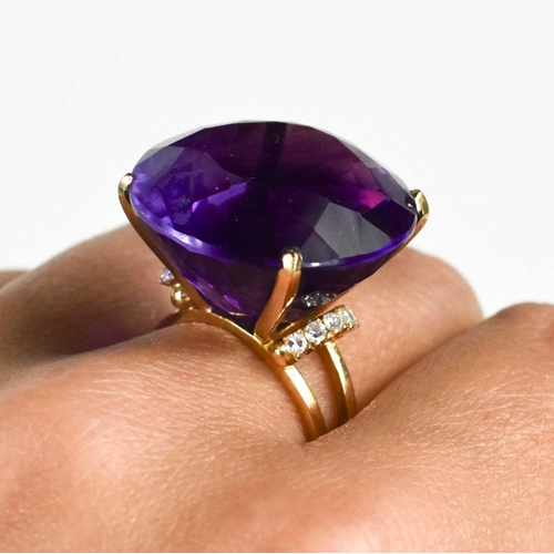 139 - A large and impressive Amethyst dress ring, the single stone of approximately 23.26mm, set in 18ct g... 