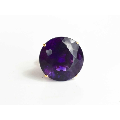 139 - A large and impressive Amethyst dress ring, the single stone of approximately 23.26mm, set in 18ct g... 