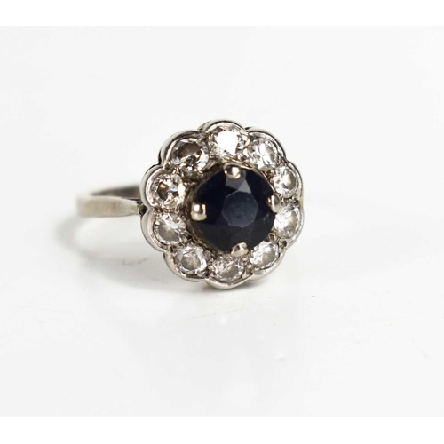 154 - A rose cut diamond and sapphire flowerhead ring, the central dark sapphire surrounded by ten diamond... 