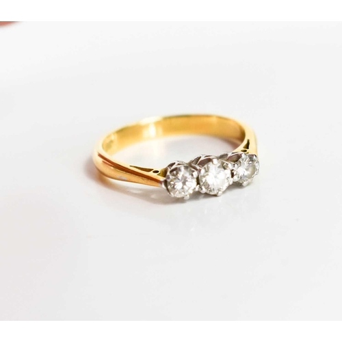 169 - An 18ct gold and diamond three stone ring, the central stone of approximately 0.25ct, 3.95mm, with t... 