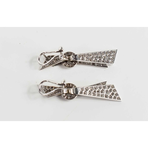 171 - A pair of 18ct white gold and diamond encrusted modernist design drop earrings, the folded ribbon ef... 