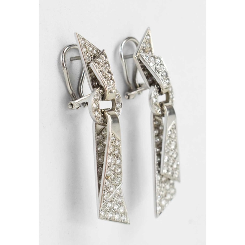 171 - A pair of 18ct white gold and diamond encrusted modernist design drop earrings, the folded ribbon ef... 