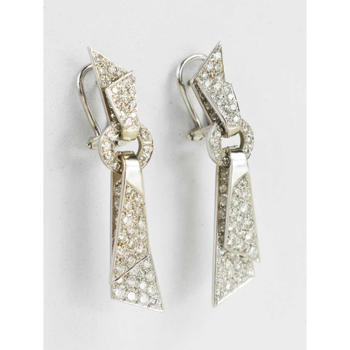 171 - A pair of 18ct white gold and diamond encrusted modernist design drop earrings, the folded ribbon ef... 