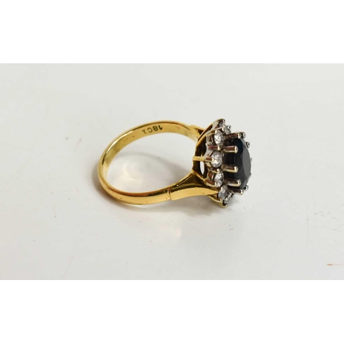 174 - An 18ct gold, sapphire and diamond dress ring, the dark blue oval cut sapphire of approximately 11.5... 