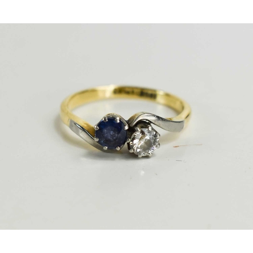 175 - An 18ct gold and platinum diamond and sapphire crossover ring, the deep blue sapphire of approximate... 