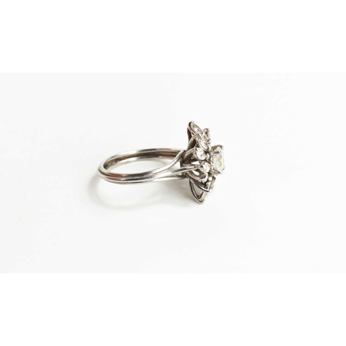 18 - A vintage diamond dress ring, of flowerhead form, the central stone of approximately 0.7ct, 5.7mm di... 