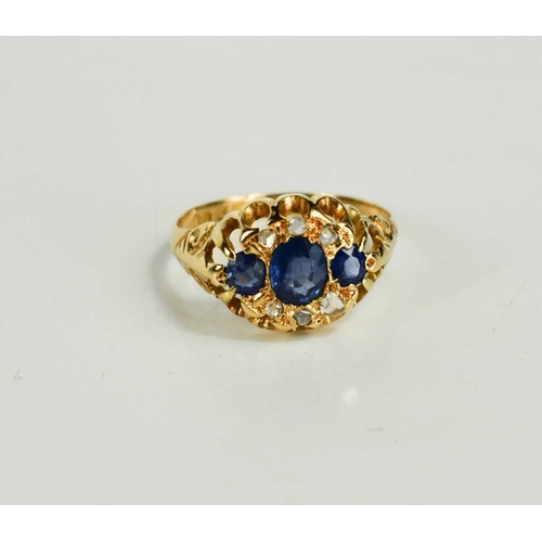 180 - A Victorian 18ct gold, blue and white sapphire dress ring, set with three graduated cornflower blue ... 