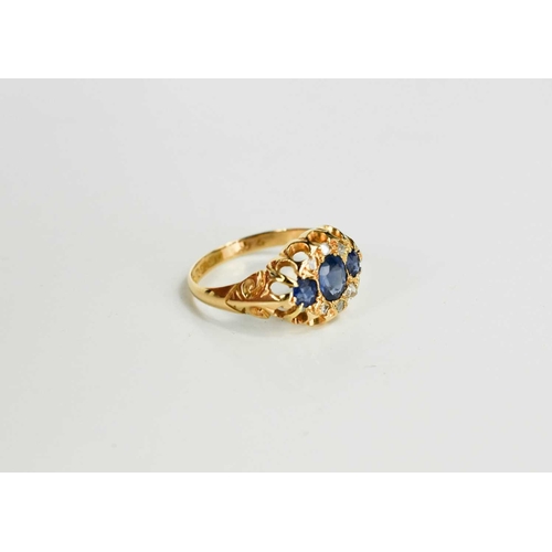 180 - A Victorian 18ct gold, blue and white sapphire dress ring, set with three graduated cornflower blue ... 