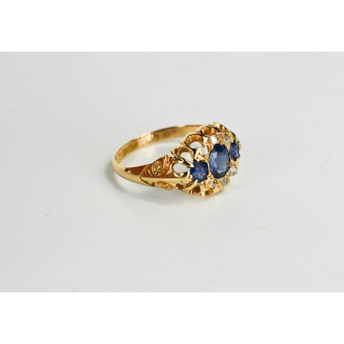 180 - A Victorian 18ct gold, blue and white sapphire dress ring, set with three graduated cornflower blue ... 