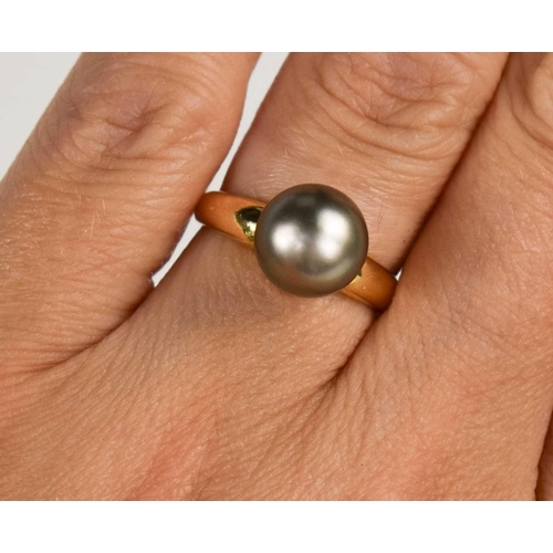 19 - An 18ct gold and pearl dress ring, the grey pearl of approximately 9.4mm, size L, 4.75g.