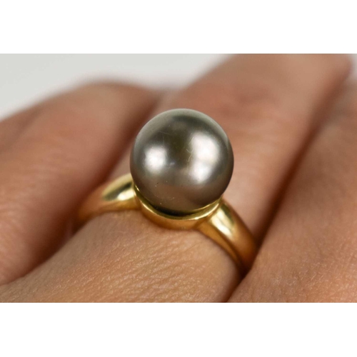 19 - An 18ct gold and pearl dress ring, the grey pearl of approximately 9.4mm, size L, 4.75g.