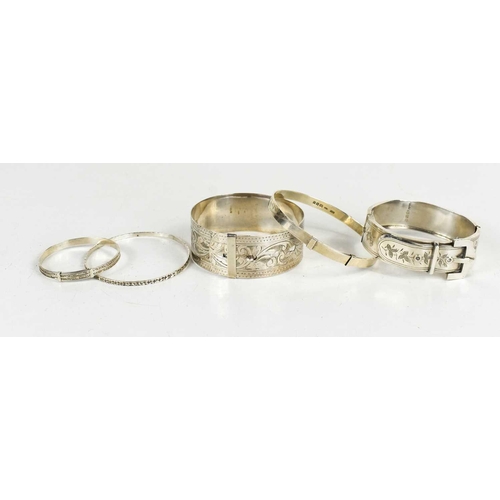 205 - A group of silver bangles, to include one in the form of a belt and buckle, Birmingham 1884, a Victo... 