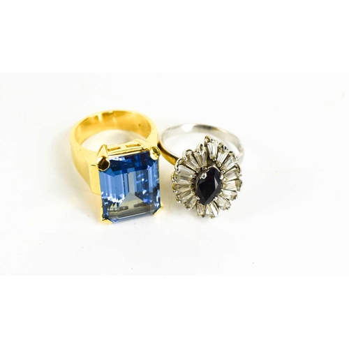 242 - A silver, sapphire and paste 20th century modernist ring, the dark marquise cut sapphire of approxim... 