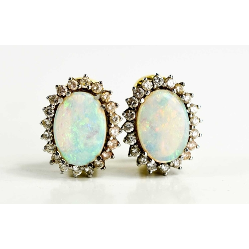 3 - A pair of 18ct gold, opal and diamond earrings, the oval opals of approximately 14 by 9.9 by 2.1mm, ... 