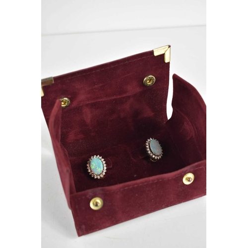 3 - A pair of 18ct gold, opal and diamond earrings, the oval opals of approximately 14 by 9.9 by 2.1mm, ... 