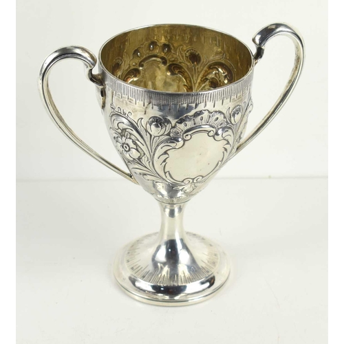 329 - A George II, Irish silver twin handled trophy, vacant cartouche and embosed with foliate decoration,... 